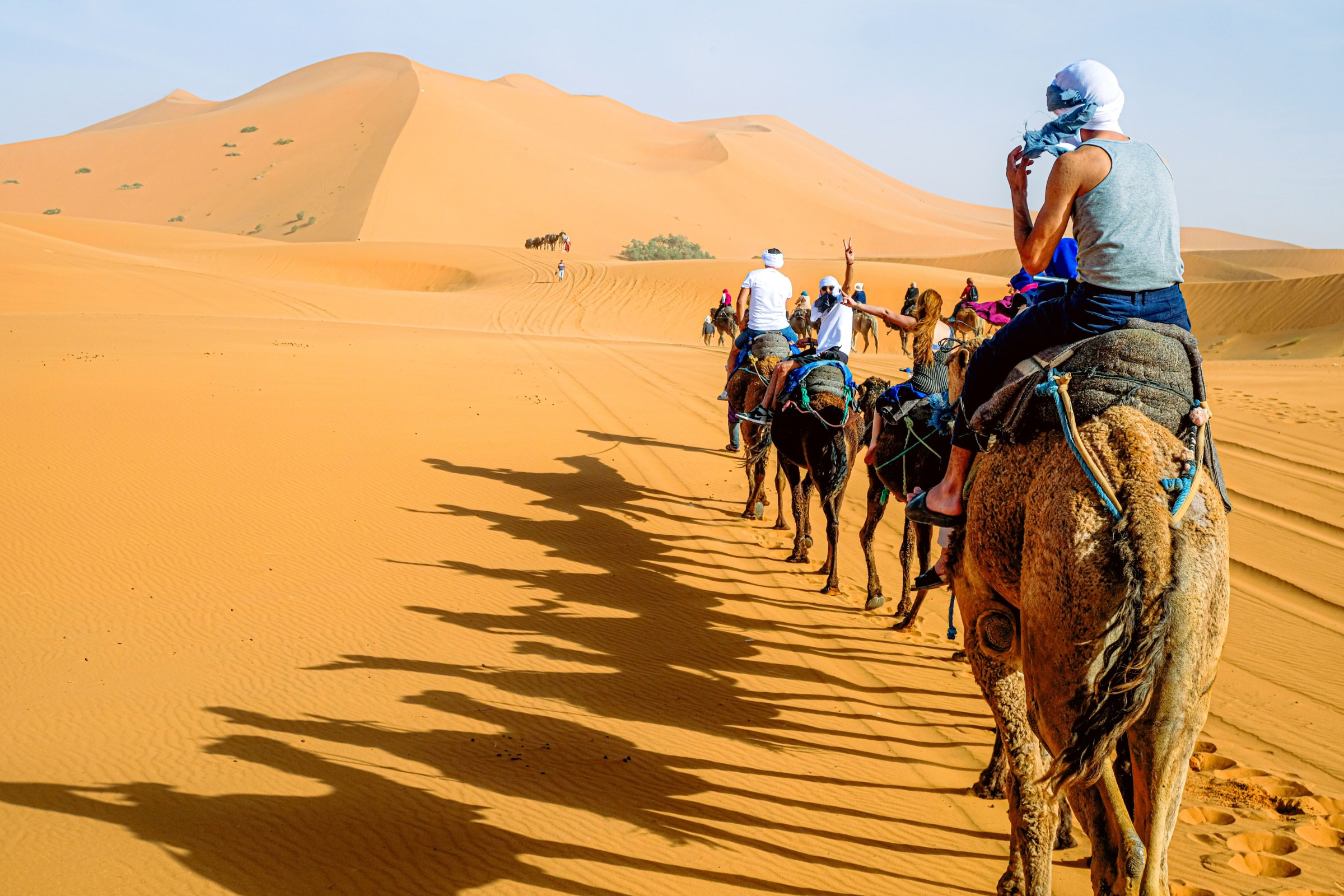 Merzouga Sahara experience with Erg Chebbi dunes, nomadic tea, Gnaoua music and private women’s group travel support.