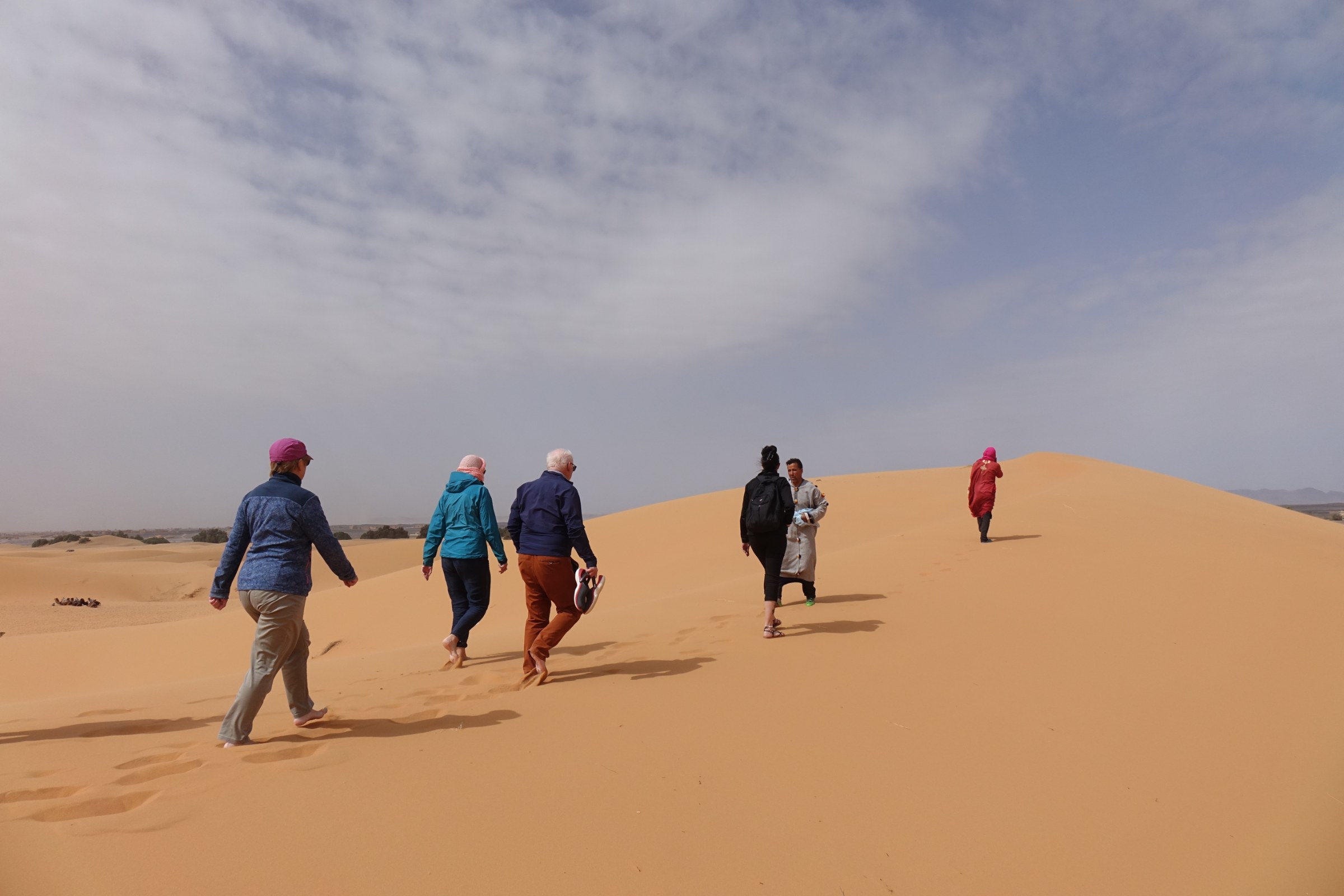 Merzouga Sahara experience with Erg Chebbi dunes, private desert camp, nomadic tea, Gnaoua music and reflective travel atmosphere.