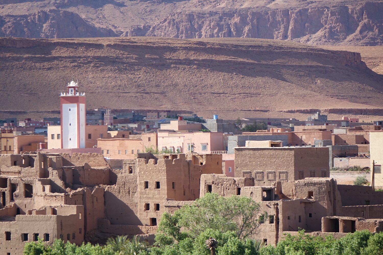 Drive from Mhamid to Ouarzazate through the Draa Valley, with palm groves, kasbah villages and desert gateway landscapes.