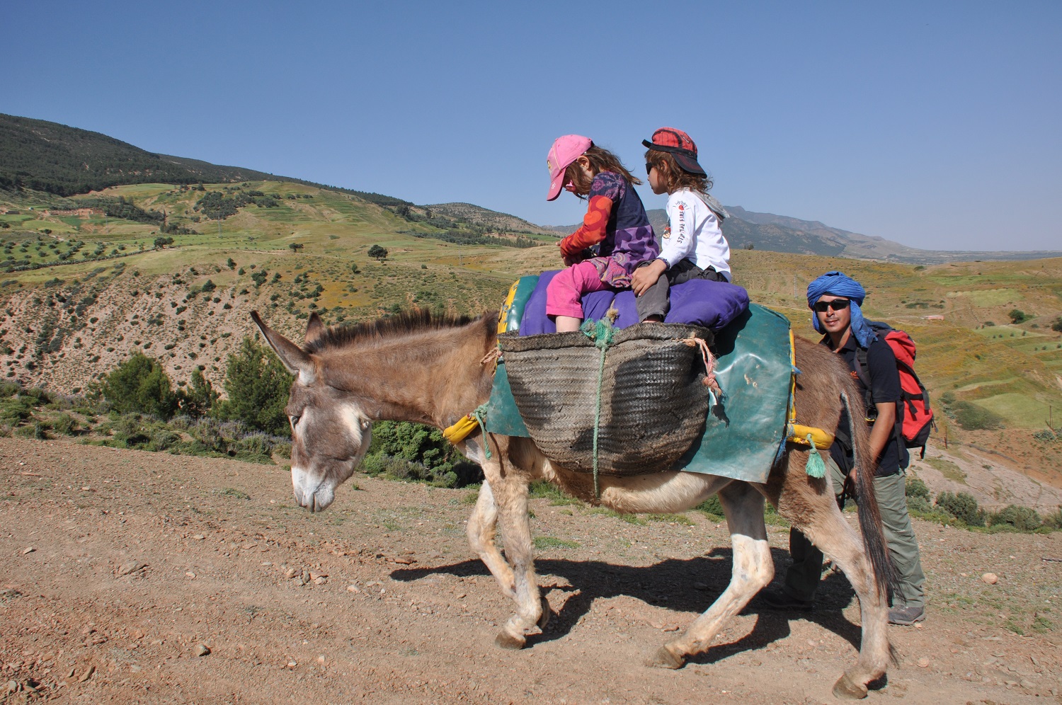 High Atlas family walk through Berber villages, terraced fields and mountain landscapes near Marrakech.
