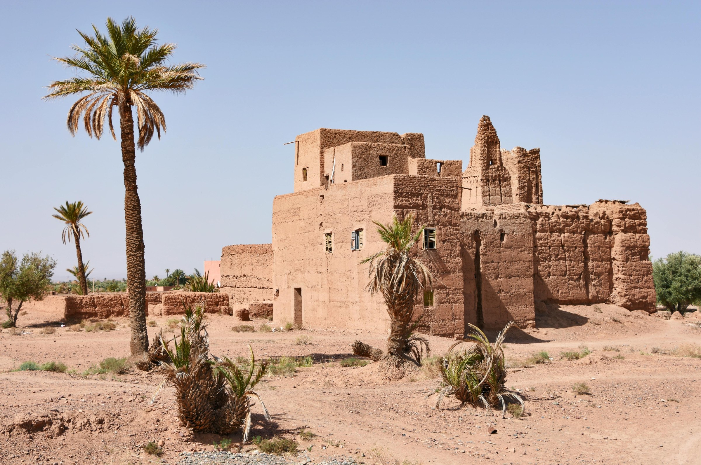 Scenic road from Ouarzazate to Marrakech through the High Atlas Mountains, with villages and panoramic views.