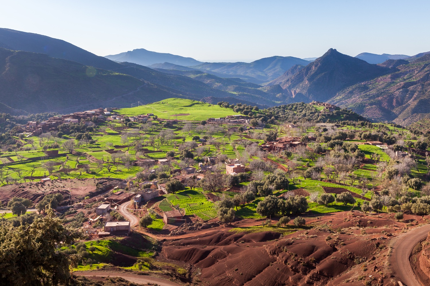 Route from Aït Bouguemez to Marrakech via Demnate, with High Atlas foothills, village landscapes and heritage context.