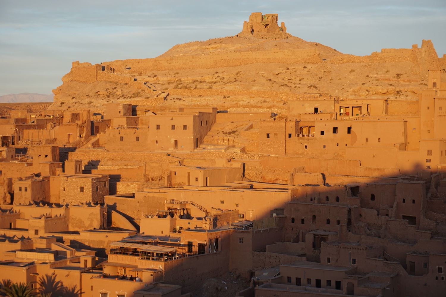 Road from Merzouga to Ouarzazate through southern Morocco, with palm groves, kasbah villages and desert-edge landscapes.